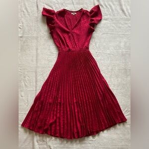Red v-neck polka-dot, pleated skirt dress